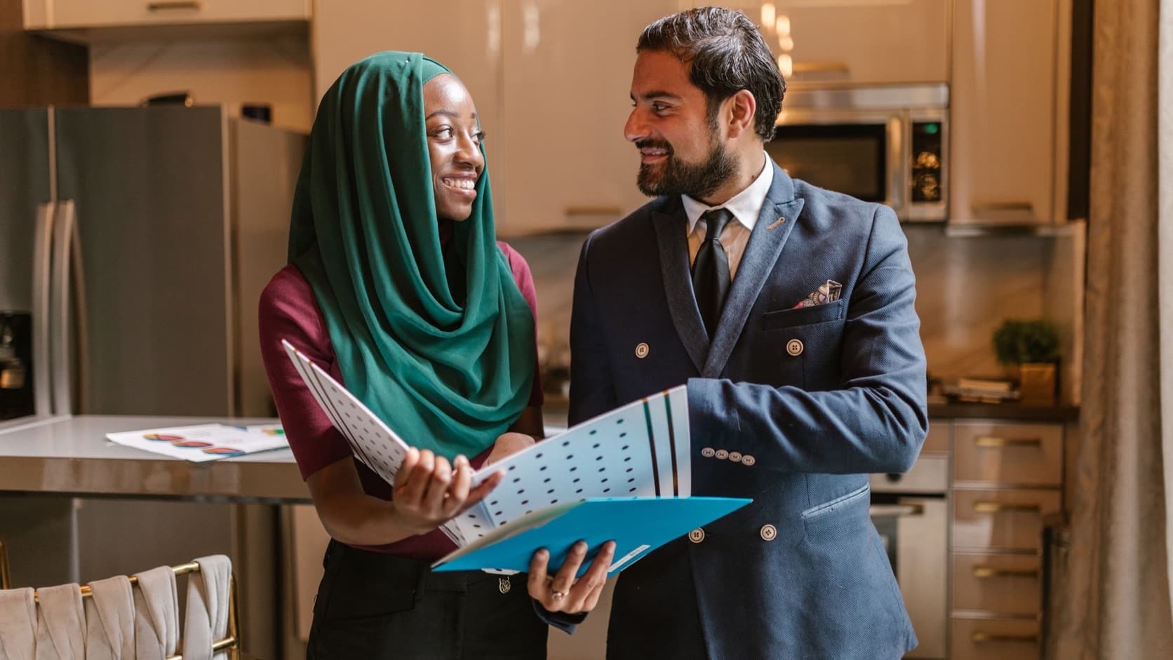 Colleagues smiling while reviewing support documents